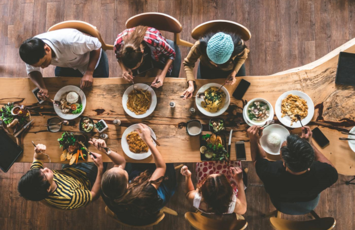 Family having lunch on a wood table  